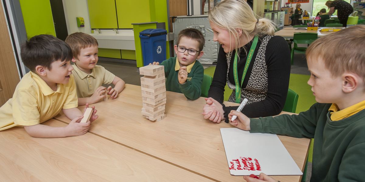 Teacher in a classroom with some children